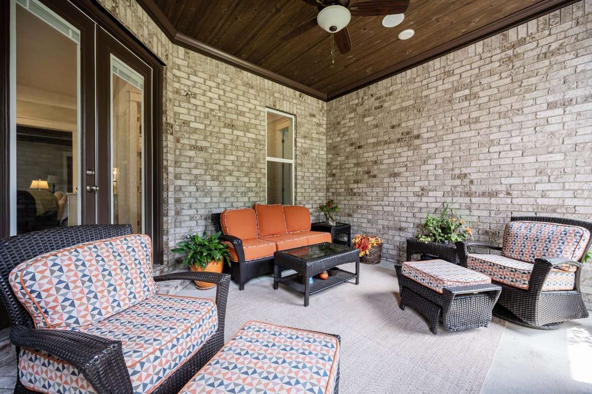 Covered patio has view of woods