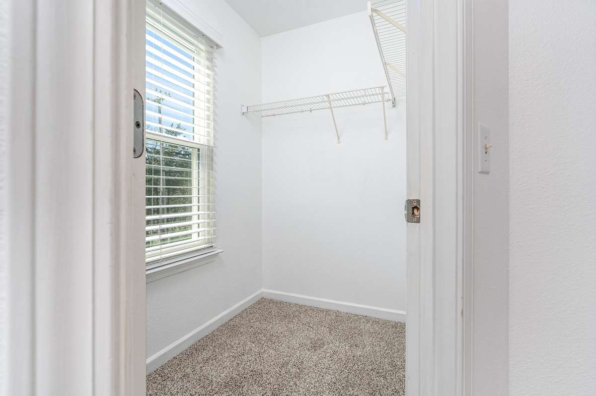 Large walk-in-closet also has sunny window