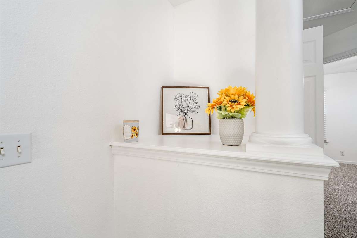 Cool shelf at the top of the stairs showcasing the fresh paint throughout