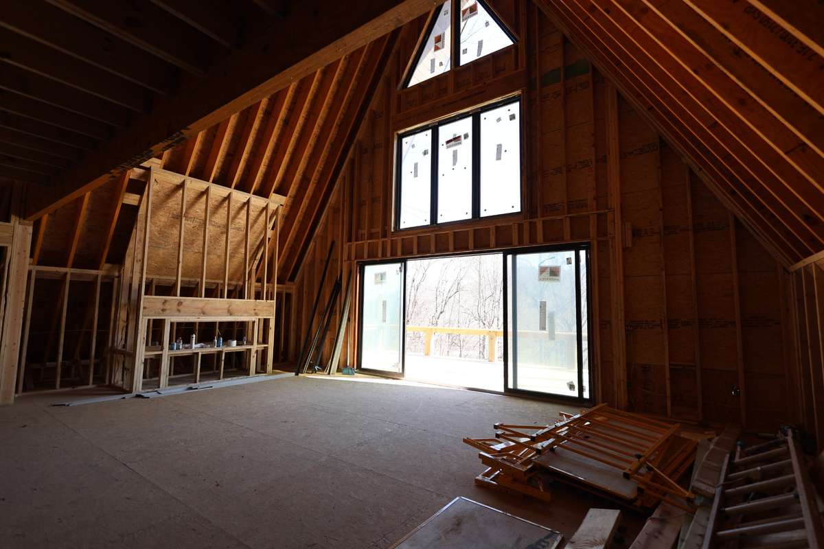 Living room, featuring a massive fire place.