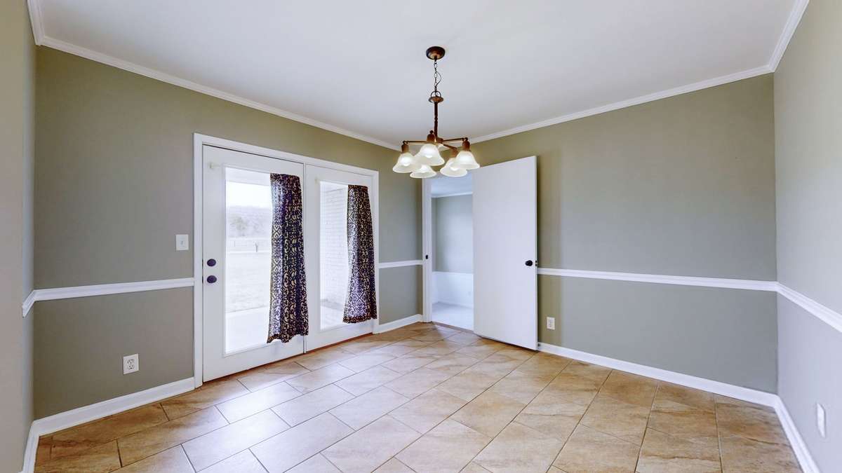 formal dining room with French doors leading to one of the front porches