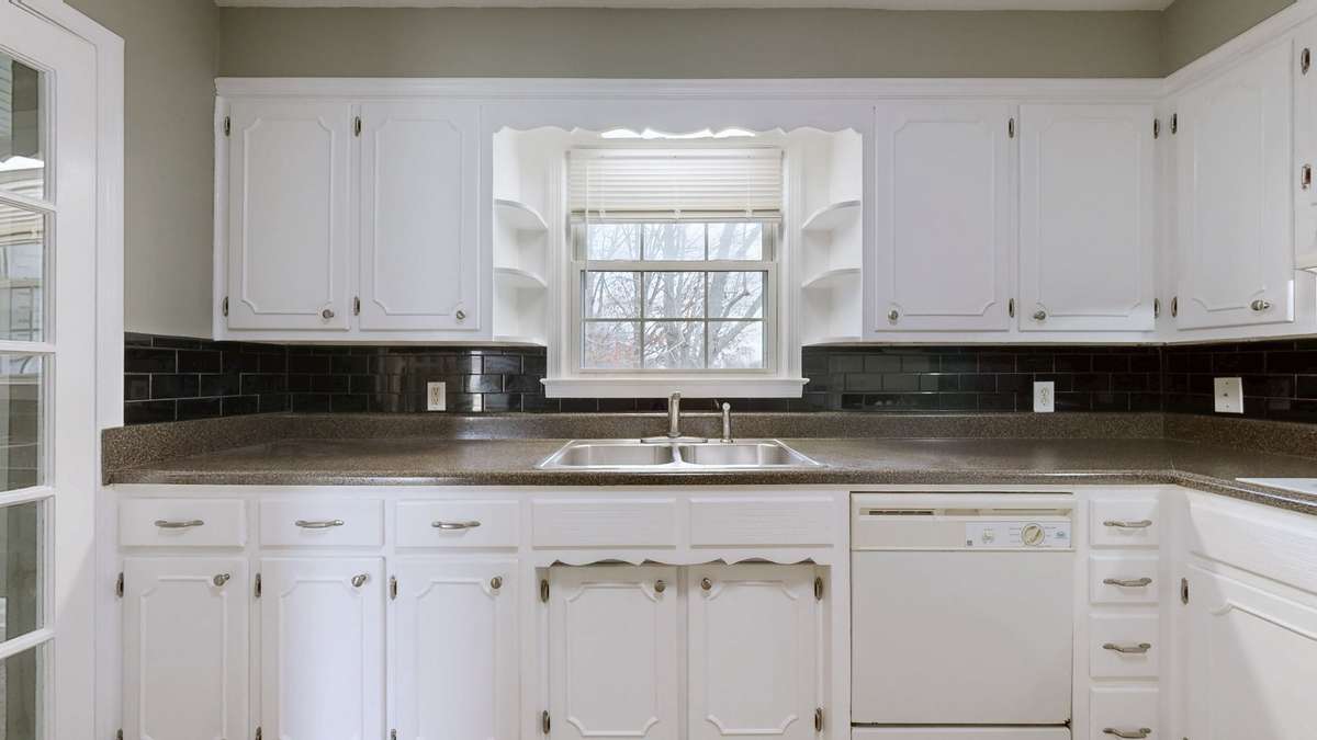 bright white cabinets + black backsplash