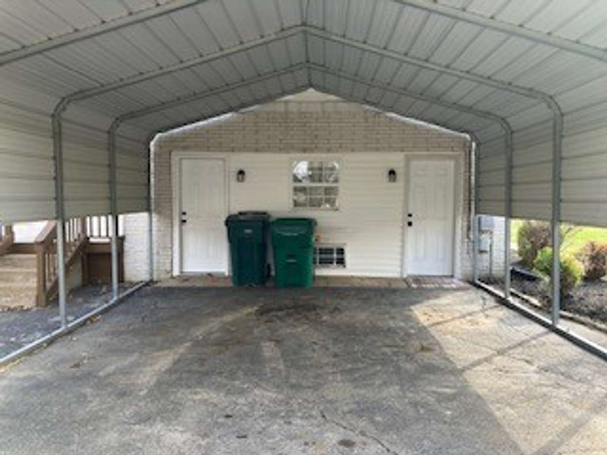 door on left under carport is a good size storage closet