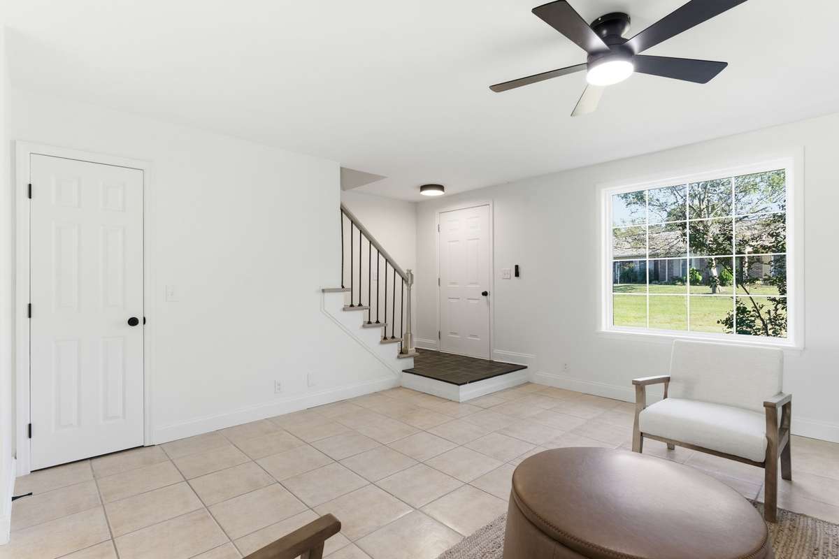 Spacious living room area with storage under the stairs.