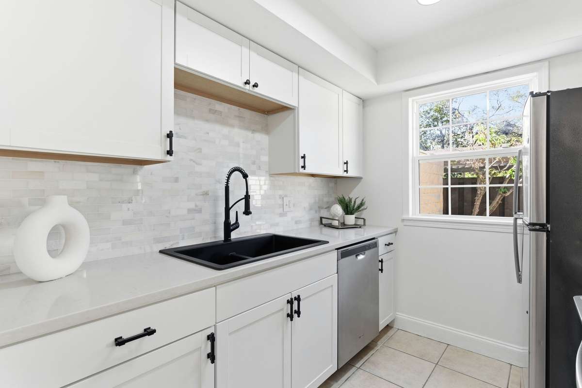 Updated kitchen with new cabinets and backsplash.