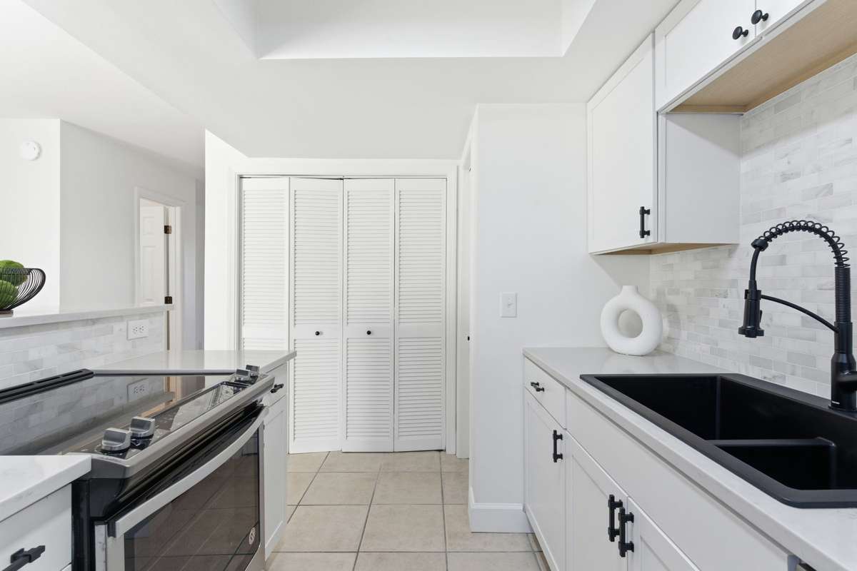 Updated kitchen with new cabinets and backsplash.