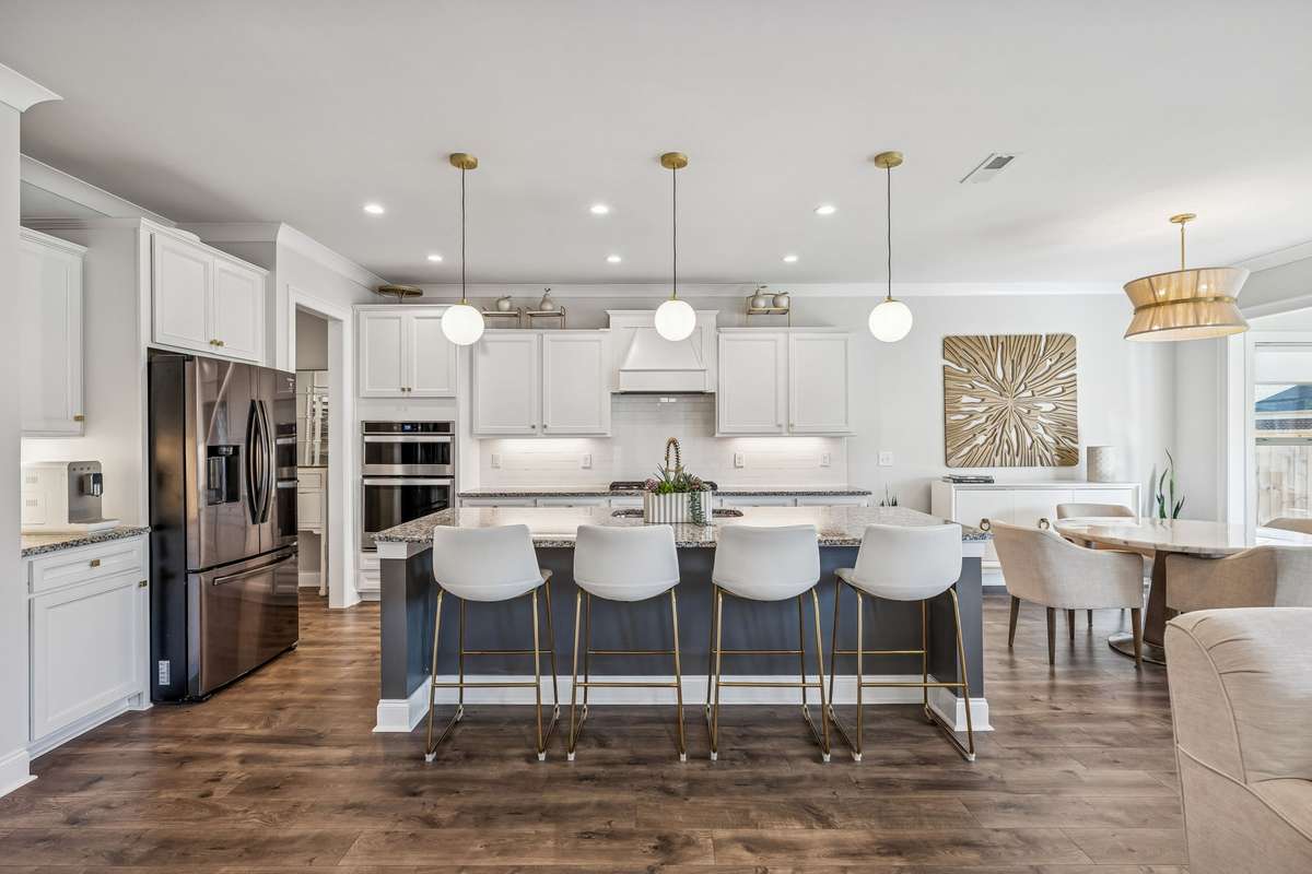 Crisp white cabinetry, granite countertops, and a classic subway tile backsplash create a timeless look in this dreamy kitchen! 606 Rumsford Lane, Mt Juliet, TN 37122