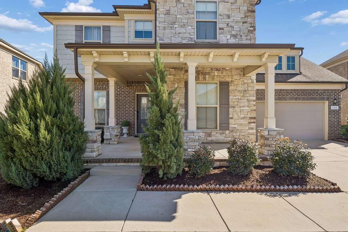 Covered porch with carefully selected exterior details of brick, stone, and shake to greet guests! 606 Rumsford Lane, Mt Juliet, TN 37122