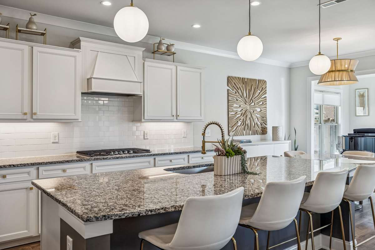 Layered lighting design with modern pendant lights, recessed ceiling lighting, and under-cabinet lighting for both style and practicality! 606 Rumsford Lane, Mt Juliet, TN 37122
