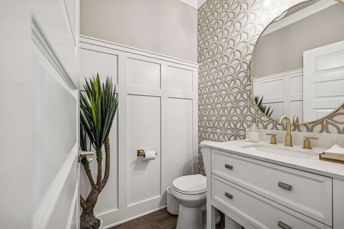 Gorgeous powder bath with wainscotting, designer accent wall, and modern vanity with mirror! 606 Rumsford Lane, Mt Juliet, TN 37122