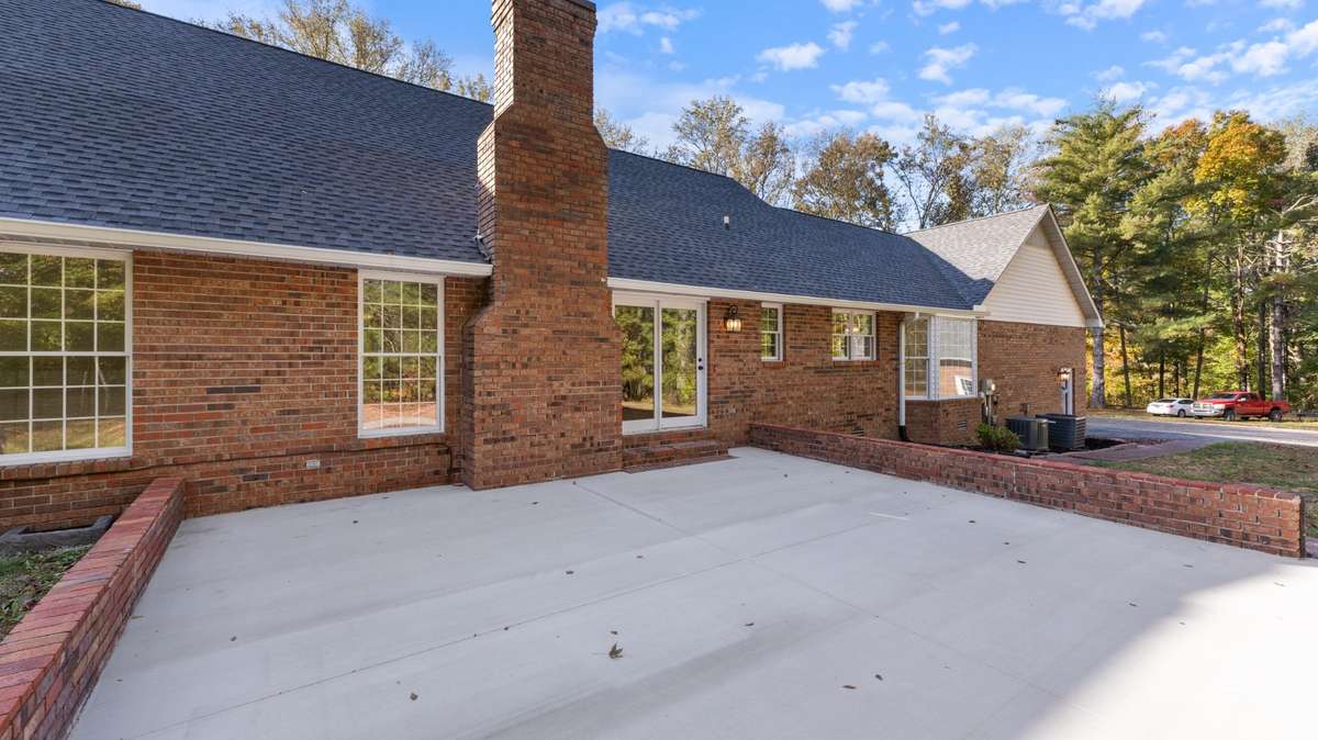 Large patio with brick wall surround.