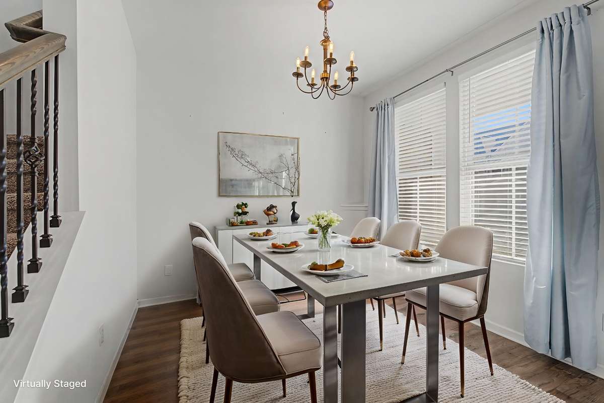 Virtually staged to show this room can be used as a dining room. The room is wider than it looks.
