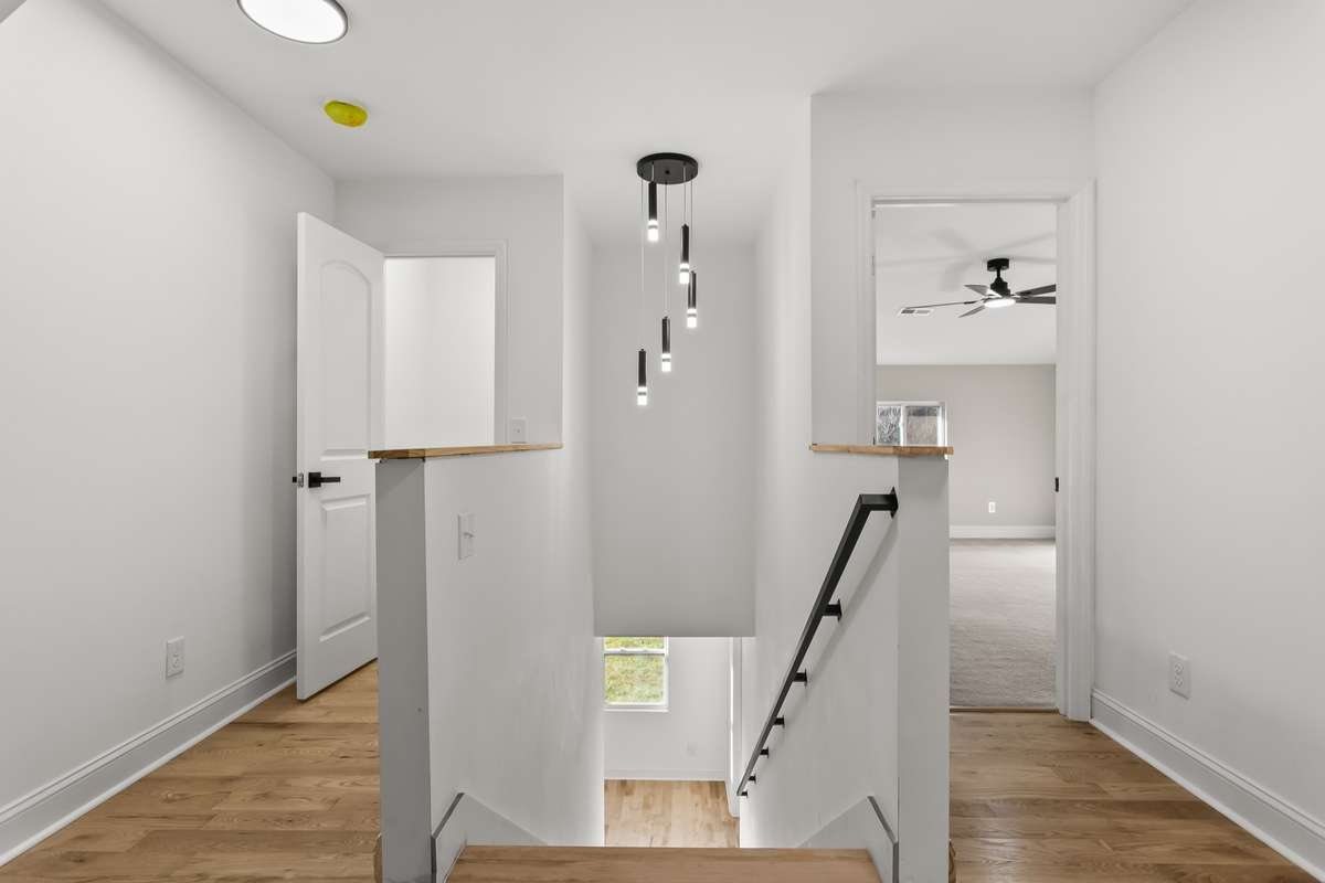 View from the top of the stairs, extra hall closet for storage and view of bedoom 4