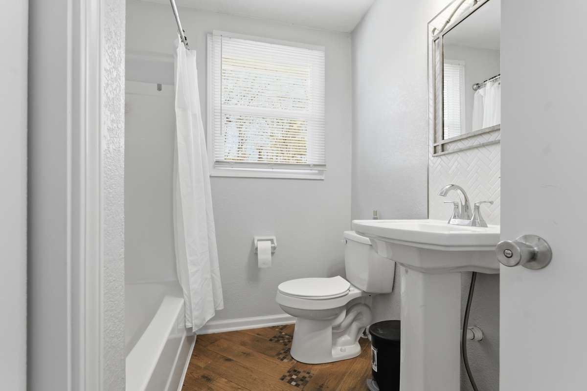Bathroom has a tub and shower combination