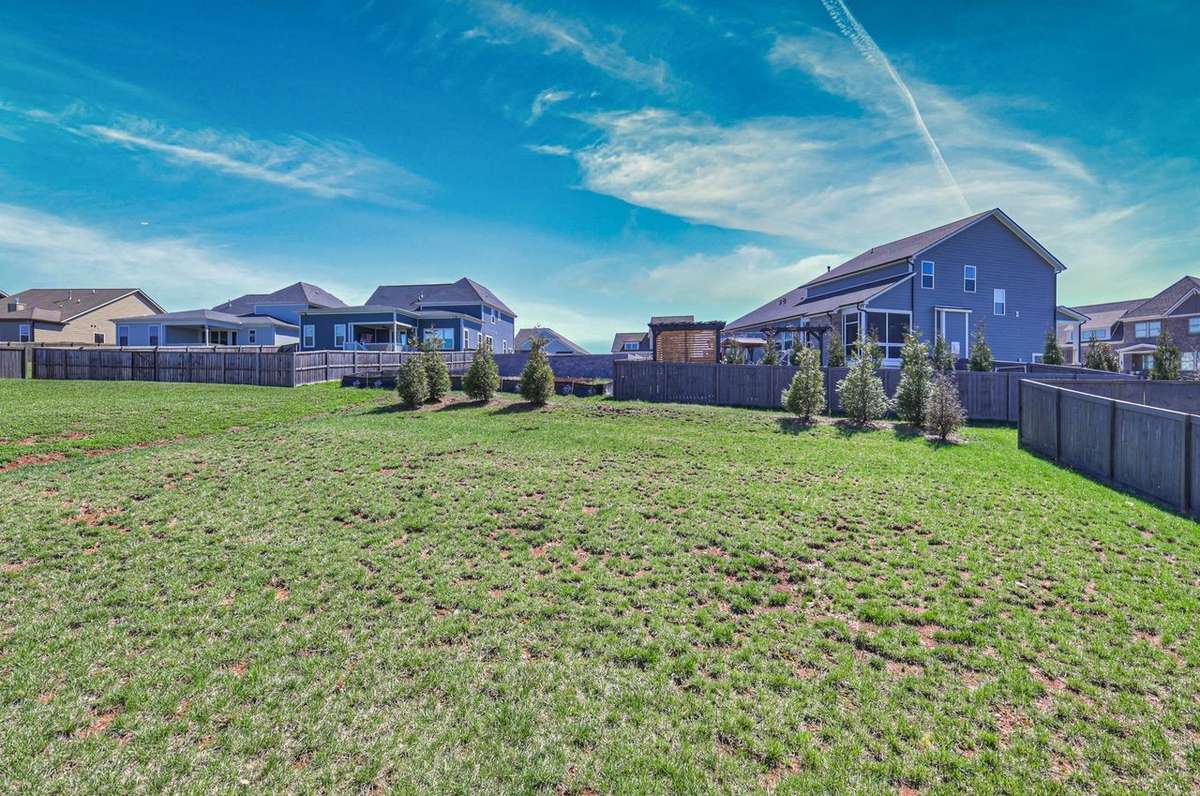 This home features a spacious backyard for kids, dogs, or entertaining.