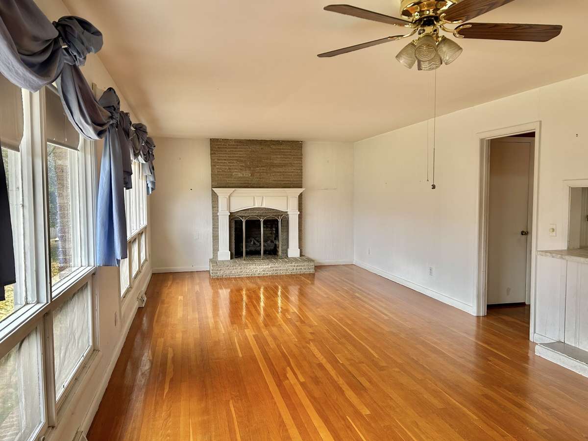 Beautiful Large living room with hardwood floors, tons of large windows to view the river, and a gas fireplace!!