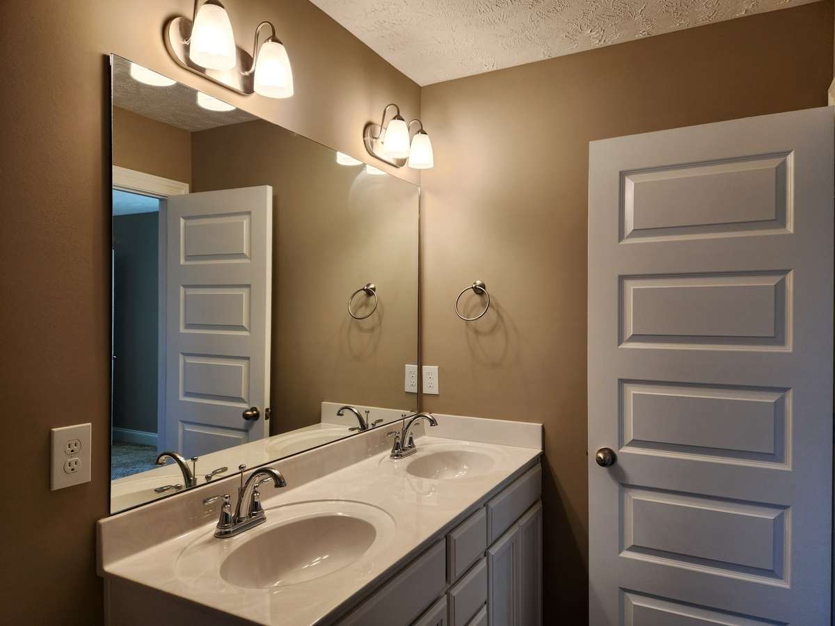 Primary Bath features 2 Sinks and Extra Storage in the Cabinets.
