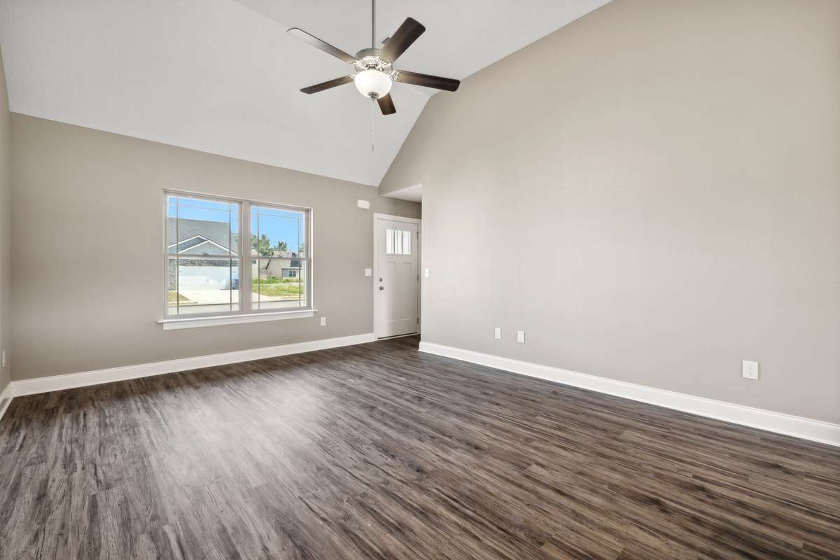 Spacious Living Room with Vaulted Ceiling & Plank Flooring.
