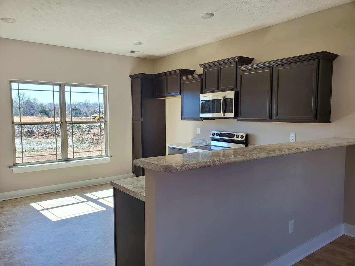 Kitchen has an abundance of Cabinets and Built-In Cabinet Pantry. Lot 72 Valley Farms will have Granite Counter Tops.  Picture of Similar House.