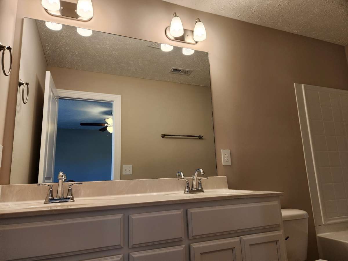 Picture of White Cabinets in Primary Bathroom.  Pictures are from a previous house.