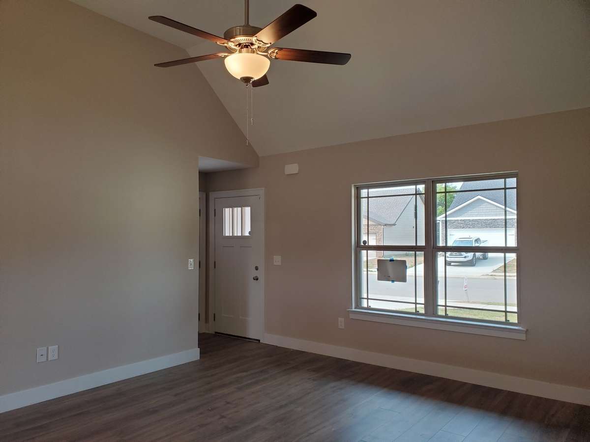 Spacious Living Room has Vaulted Ceiling and Ceiling Fan.  Picture of Similar House.