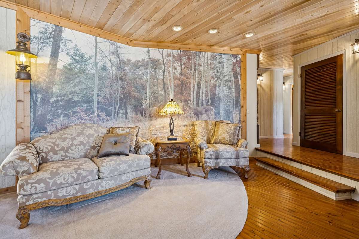 Warm and inviting lounge space ideal for conversation and gathering, highlighted by natural wood finishes and distinctive character! 1372 Short Mountain Rd, McMinnville, TN 37110