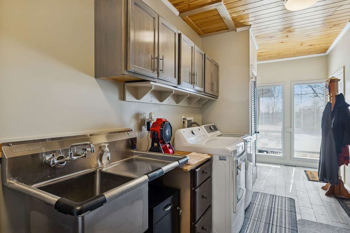 Spacious laundry/mud room flooded with natural light includes cabinetry and an industrial, utility sink and you'll never run out of hot water as there are two water heaters & one was just replaced! 1372 Short Mountain Rd, McMinnville, TN 37110