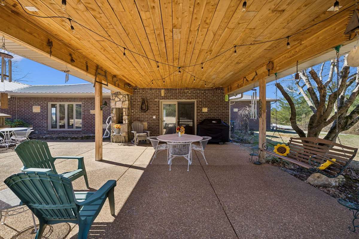 Inviting outdoor space offers this large, covered patio overlooking your private backyard and surrounding property! 1372 Short Mountain Rd, McMinnville, TN 37110