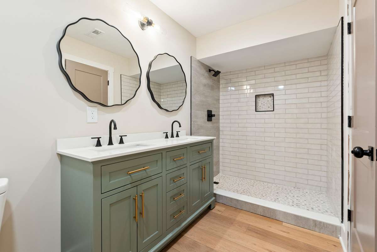 Thoughtfully designed full bath with custom  double sink vanity, modern hardware, and a sleek walk-in shower—offering comfort and privacy for guests!  510 Iris Avenue, Murfreesboro, TN 37128