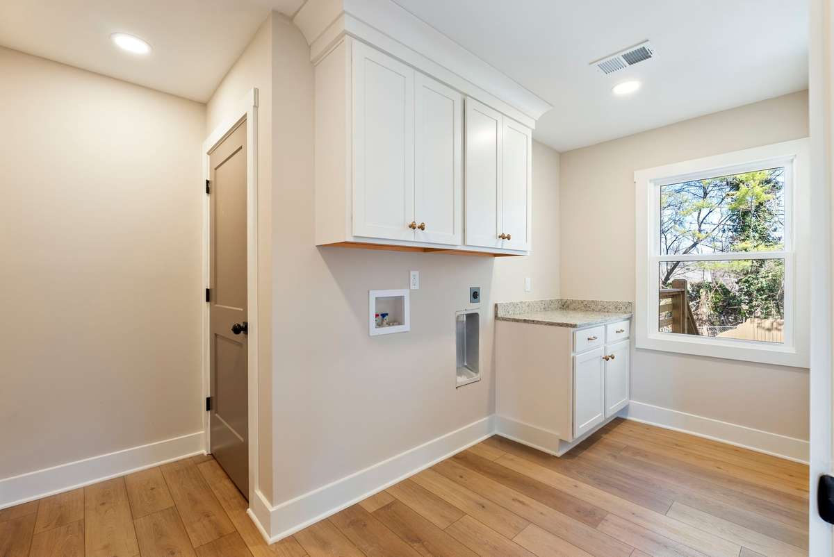 Enjoy the convenience of two laundry rooms with custom cabinetry and folding space! 510 Iris Avenue, Murfreesboro, TN 37128
