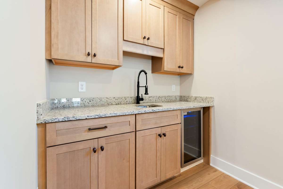 Fully finished lower level featuring a large open living area and wet bar with custom cabinetry and mini-fridge! This lower level could be perfectly utilized as an income producing space!  510 Iris Avenue, Murfreesboro, TN 37128