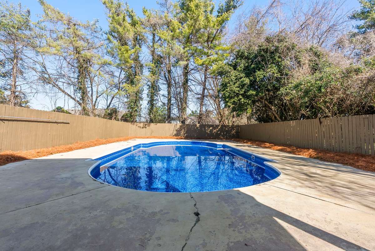 Spacious fenced yard anchored by a sparkling pool with a new pool liner and pump—ideal for hosting, gathering, and creating lasting memories! 510 Iris Avenue, Murfreesboro, TN 37128