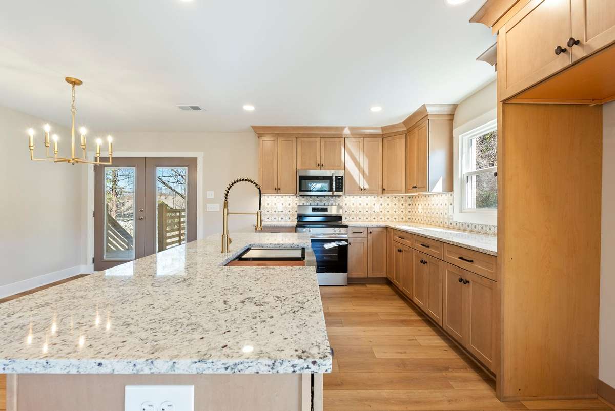 Spacious dining area designed for gathering, highlighted by new luxury vinyl plank flooring, updated lighting, and direct access to the deck—perfect for hosting poolside dinners and weekend entertaining! 510 Iris Avenue, Murfreesboro, TN 37128