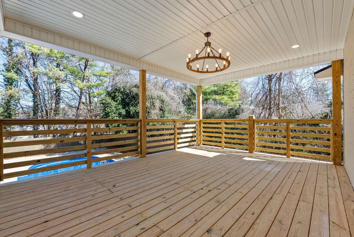 Custom-built covered deck with decorative lighting and durable finishes—offering both shade and style while overlooking the fully fenced backyard and sparking pool! 510 Iris Avenue, Murfreesboro, TN 37128