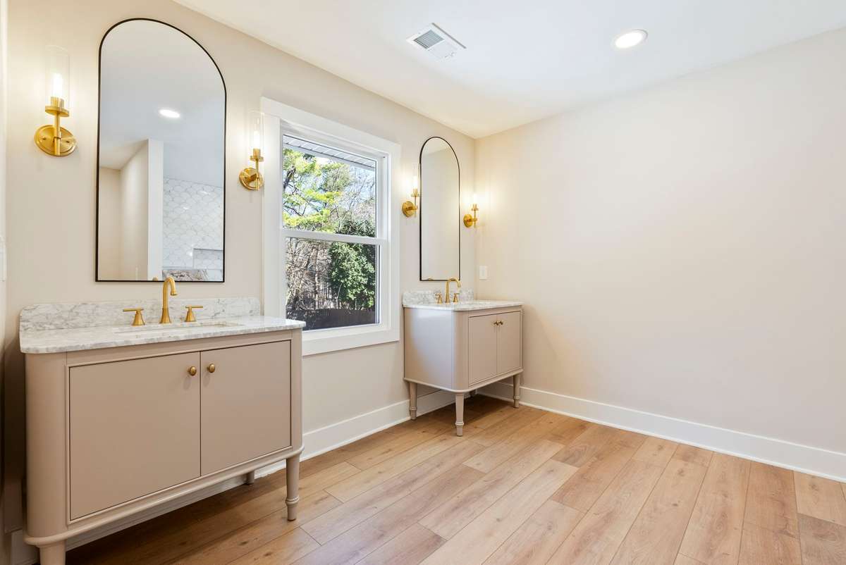 Completely reimagined ensuite with double vanities, custom lighting including sconces and recessed lighting, marble surfaces, and statement hardware for a refined, custom feel! 510 Iris Avenue, Murfreesboro, TN 37128