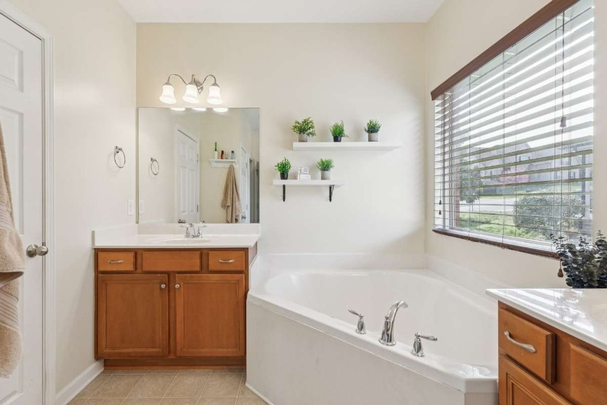 Primary bath with tub and shower. It also has two vanity areas with a walk in closet