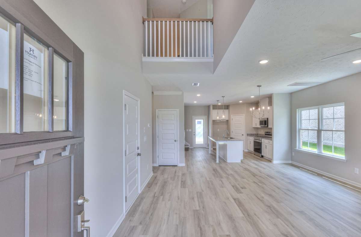 Open Living Room/ Kitchen/ Upstairs Bannister
