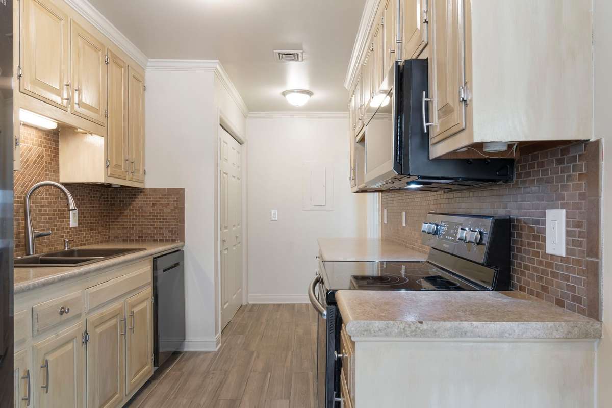 Bright kitchen has window overlooking the lovely back deck.