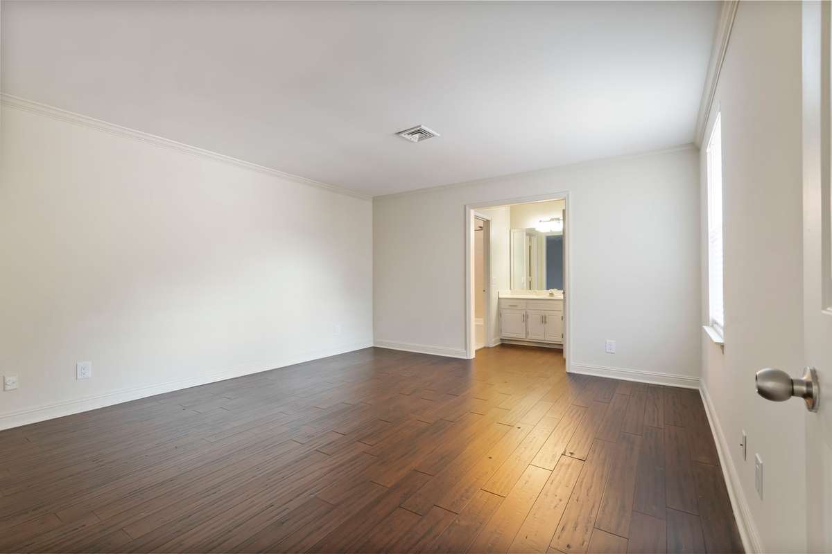 Primary Bedroom with view into bath