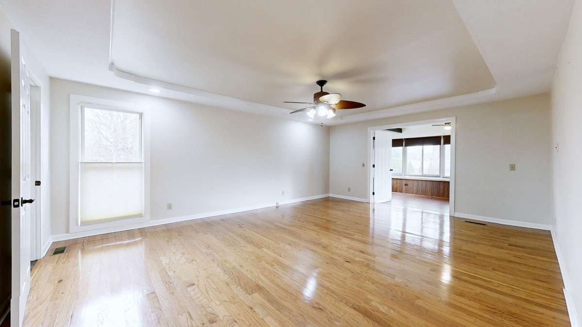 Primary Bedroom with Double Doors Open to Sunroom