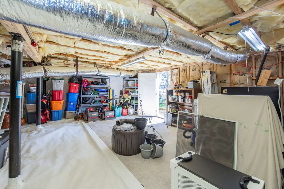 Stand up crawl space encapsulated with dehumidifier and sump pump.  Great for storage and a workshop space.