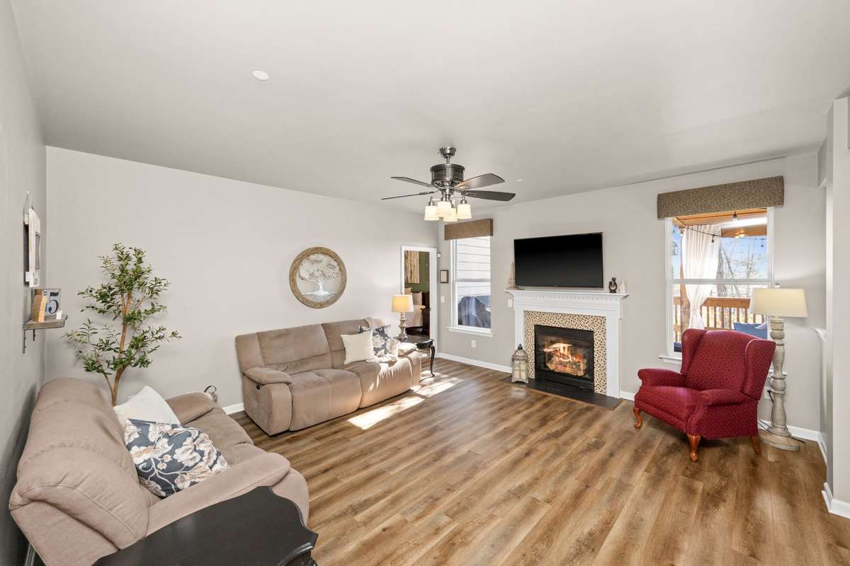 Living room with LVP flooring and gas fireplace