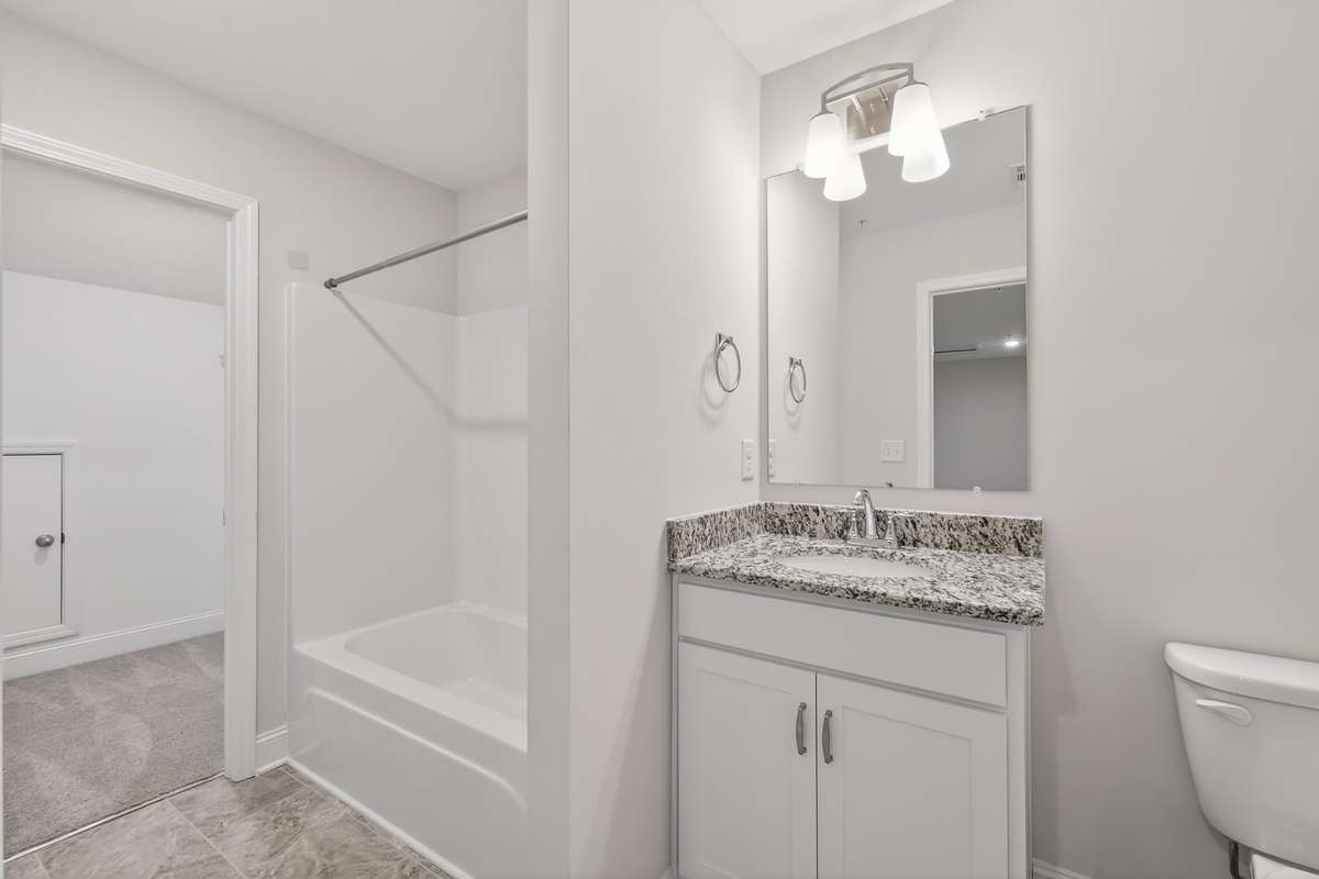 upstairs full bathroom with closet and storage