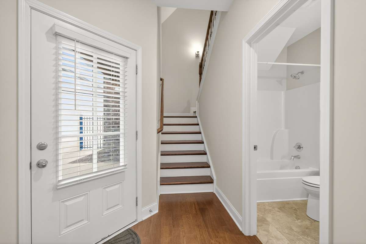 Stairs to upstairs and doorway to courtyard area