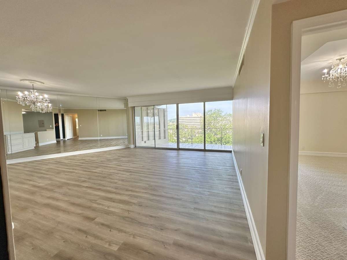 The spacious living and dining feature fresh paint, flooring and an original chandelier.