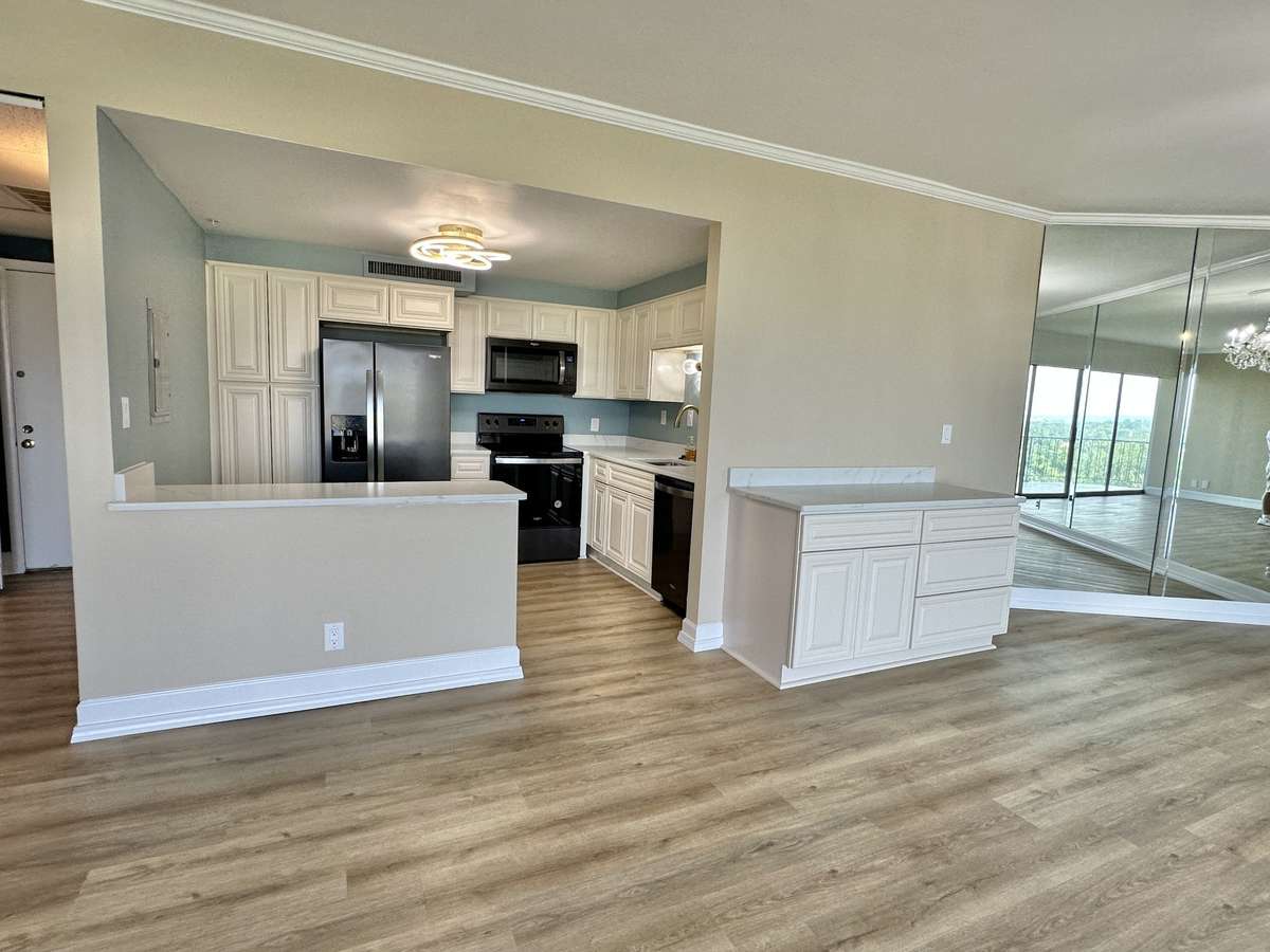 Additional cabinets between the kitchen and dining room create a place for food service, bar area or coffee station.