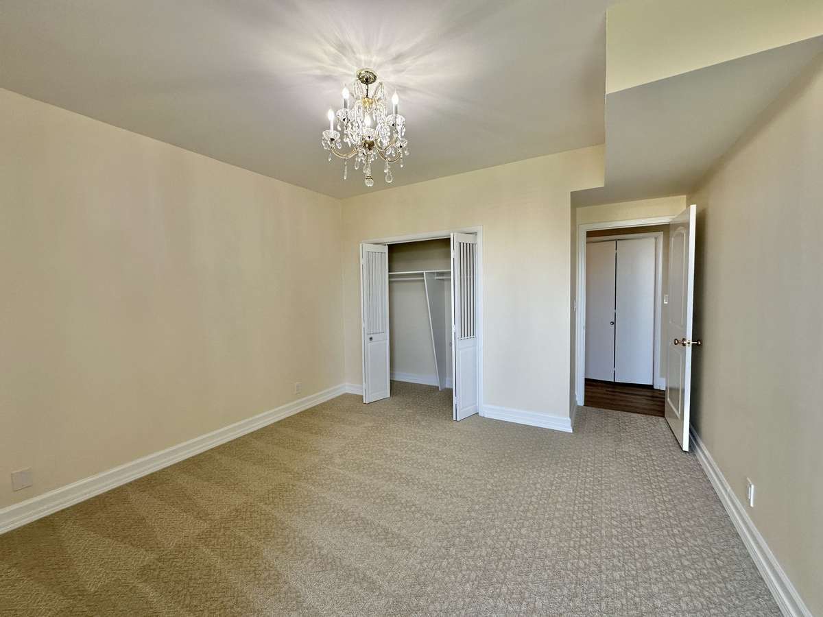 Guest bedroom with original chandelier.