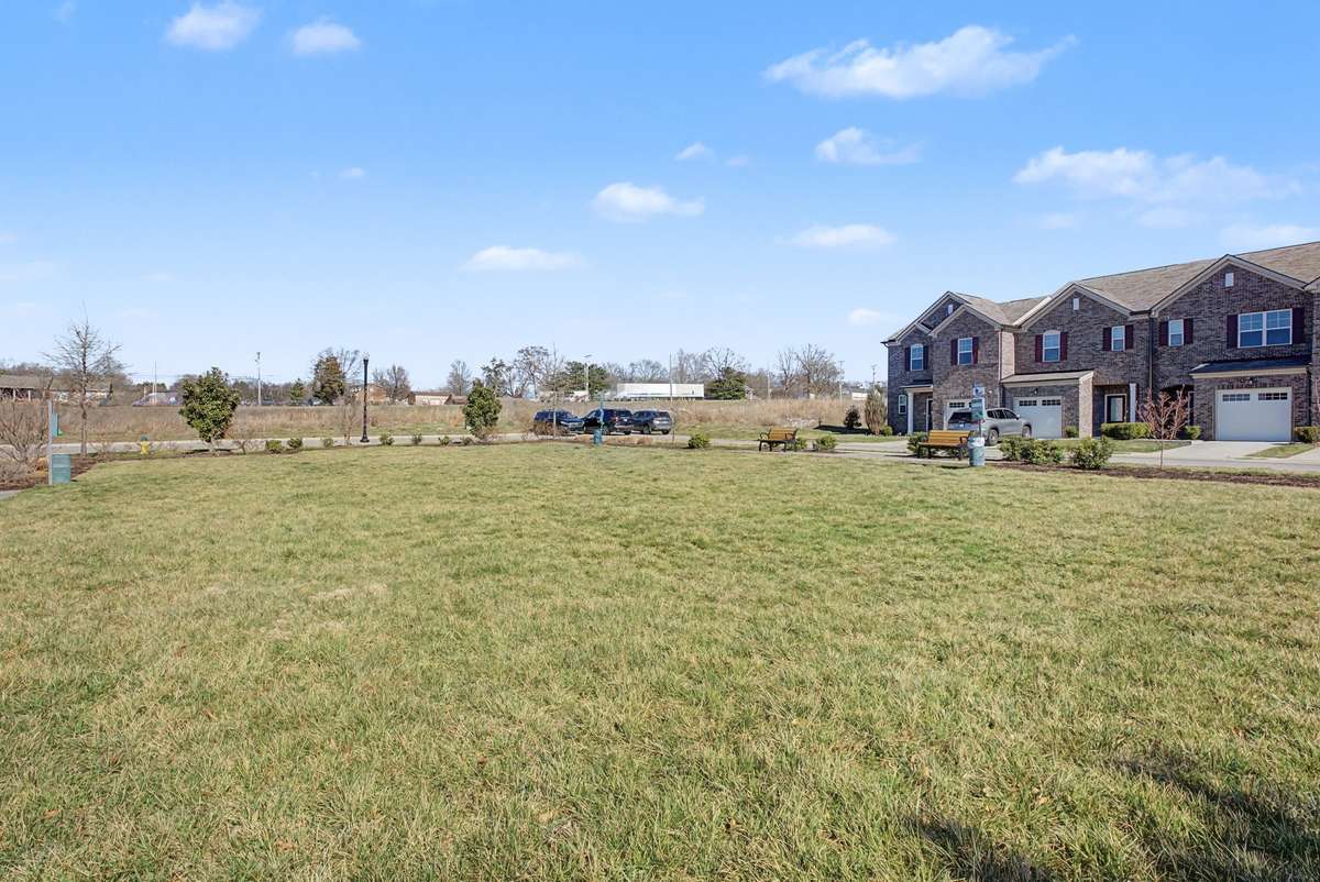 The open green space across from the unit is perfect for relaxing outdoors and gives kids and pets plenty of room to play and enjoy the fresh air.