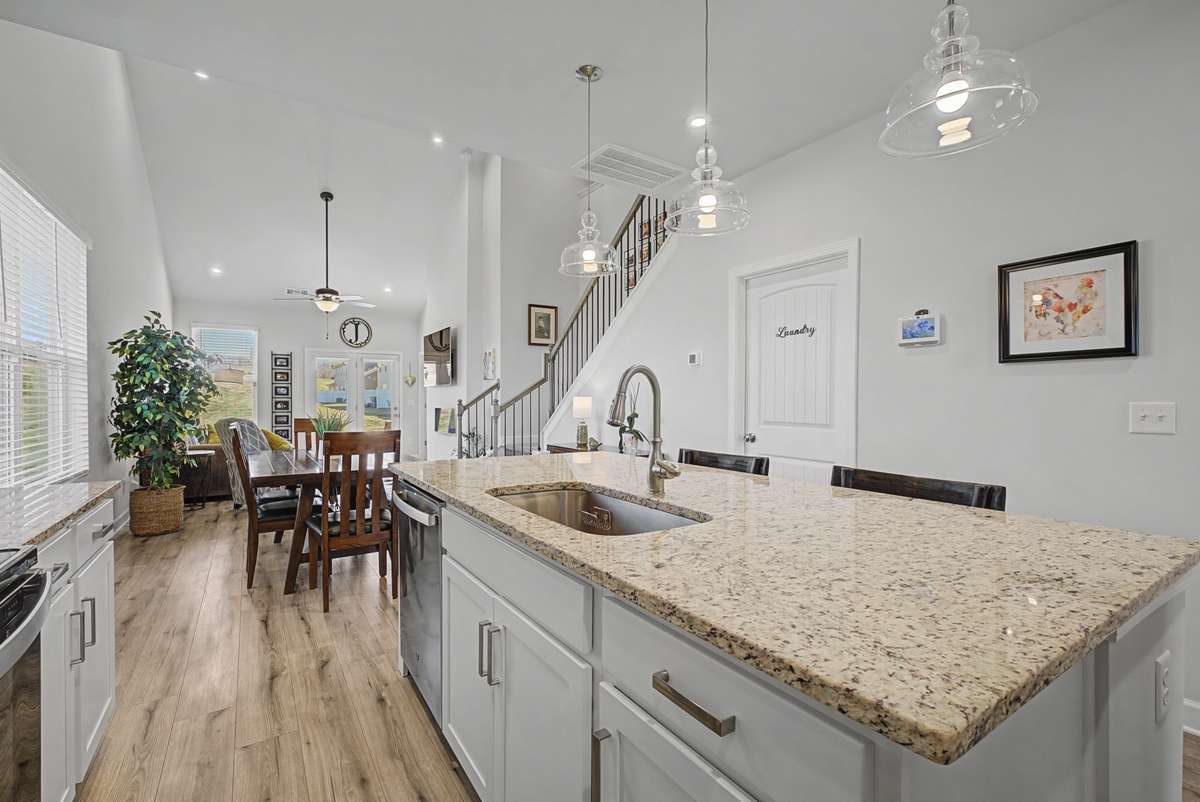 The great room is bright, open and welcoming, filled with natural light that pour through large windows. Its open concept design creates seamless flow that's perfect for gathering with family and friends.