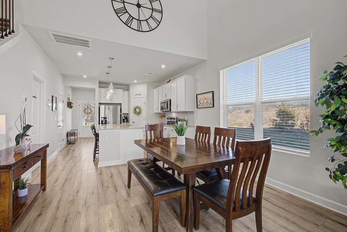 Spacious dining area with large windows that pour light into the room.